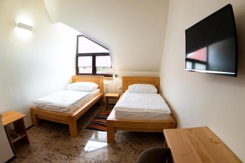 Postel nebo postele na pokoji v ubytování Hotel Sluneční dvůr