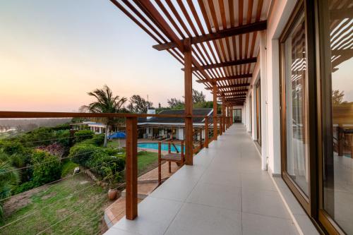 a balcony with a view of the ocean at The Ridge Guesthouse in Richards Bay