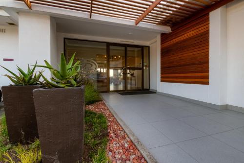 an entrance to a building with plants in front of it at The Ridge Guesthouse in Richards Bay