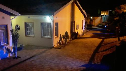 an empty street at night with a house at Vuya Nathi Bed and Breakfast in Manzini