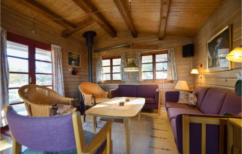 a living room with a couch and a table and chairs at Gimle in Bolilmark