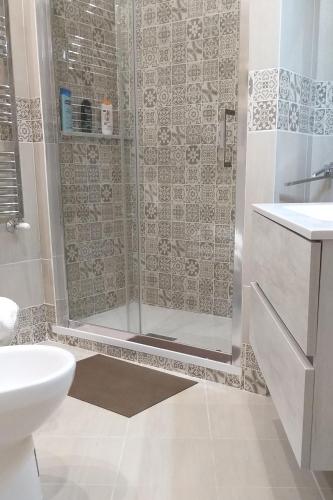 a bathroom with a shower with a toilet and a sink at Pompei Center Life Atmosphere in Pompei
