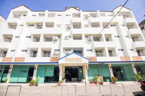 a white building with a sign in front of it at SLT Apartment Bangkok in Bangkok