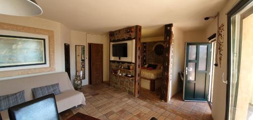 a living room with a couch and a tv at Studio-apartments Monfort in Portorož