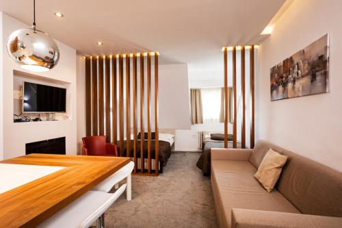 a living room with a couch and a table in a room at Snow White apartments in Kopaonik