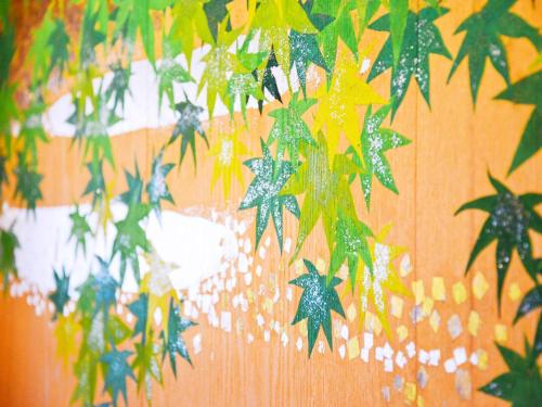 a bunch of stars hanging from a wall at jyozankei Shikanoyu in Jozankei