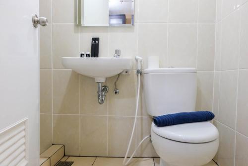 a bathroom with a toilet and a sink at Luxury and Cozy Studio Apartment M-Town Residence By Travelio in Tangerang