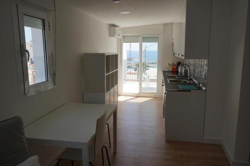 a kitchen with a sink and a counter top at Pescadors Apartamentos by TRG in Benidorm