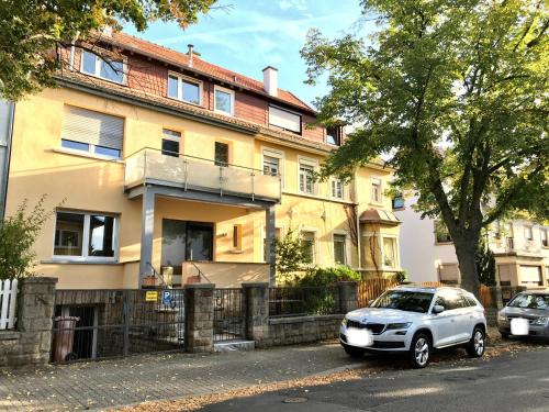 a white car parked in front of a building at Ferienwohnung Forest & Wein in Neustadt an der Weinstraße