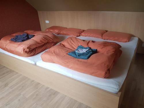 a bed with two pillows on top of it at Hier begint den hemel. in Beffe