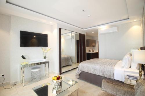 a hotel room with a bed and a living room at APARTMENTS GH - Accra - Airport Residential Area - Mirage Residence in Accra