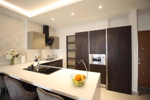 a kitchen with a bowl of fruit on a counter at APARTMENTS GH - Accra - Airport Residential Area - Mirage Residence in Accra