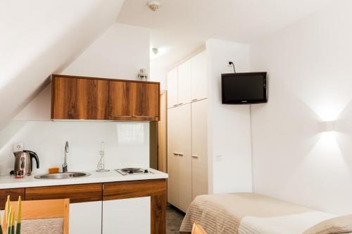 a small kitchen with a sink and a bed at Snow White apartments in Kopaonik