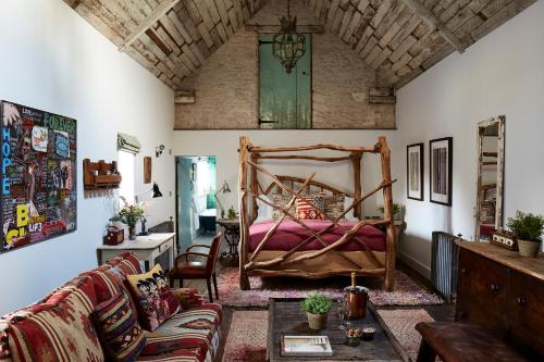 a living room with a bed and a couch at Artist Residence Oxfordshire in Oxford