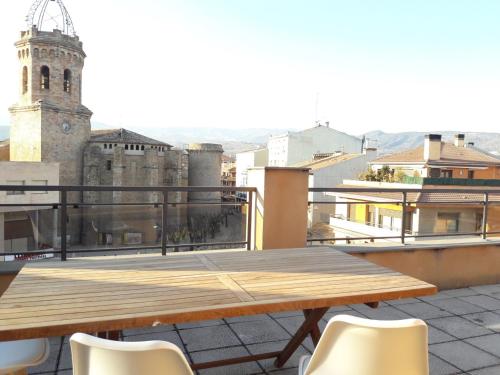 a wooden table on the roof of a building at Precioso Duplex Cal Richi in Tremp