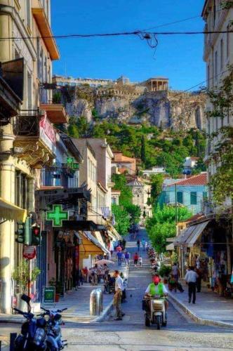 a city street with a mountain in the background at AEOLIS SUITES in Athens