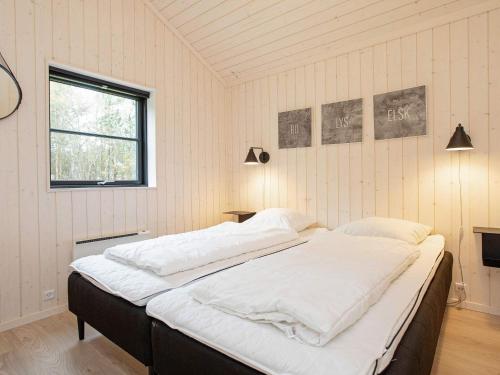 a bedroom with a large bed with white sheets at Holiday home Vig X in Vig