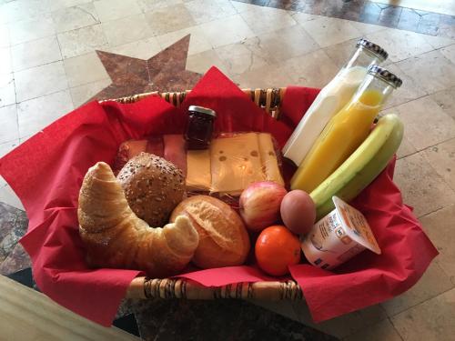 a basket of food with bread fruit and milk at Ferienhof A&B Wellness Villa 12 personen in Bullange