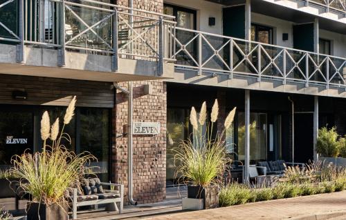 a facade of a building with plants in front of it at Just Eleven in Sankt Peter-Ording