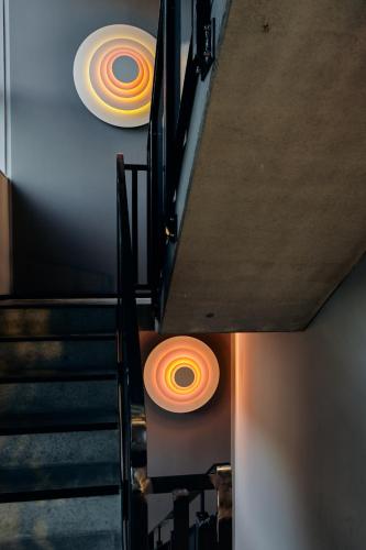 a staircase with orange and white disks on the ceiling at Just Eleven in Sankt Peter-Ording