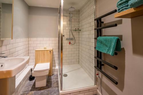 a bathroom with a shower and a toilet and a sink at 316 Westgate in York