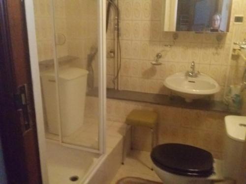 a bathroom with a shower and a toilet and a sink at Charlierhelling app 22 in Blankenberge