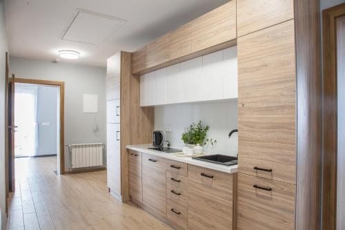 a kitchen with wooden cabinets and a counter top at Willa-Wita in Kalwaria Zebrzydowska