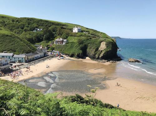 a beach with a group of people on it at Maesyfelin Isaf Apartment in Llanybydder