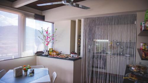 a dining room with a table and a window at B&B Panoramic in Valguarnera Caropepe