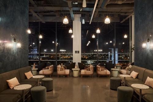 a restaurant with a view of the city at night at ARK Canary Wharf in London