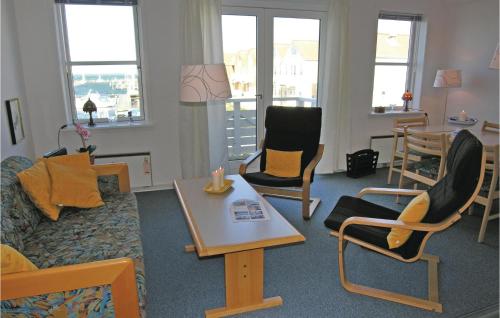 a living room with chairs and a couch and a table at Apartment Rudkøbing With Sea View Viii in Rudkøbing