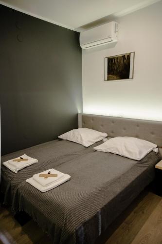 a bedroom with two beds with towels on them at ULMA studio in Wieliczka