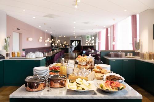 a table with food on it in a restaurant at Elite Grand Hotel Norrköping in Norrköping