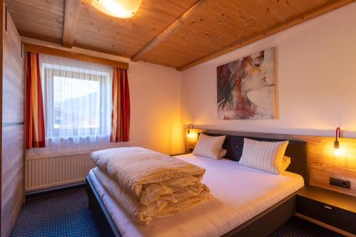 A bed or beds in a room at Haus Klaudia Gstrein