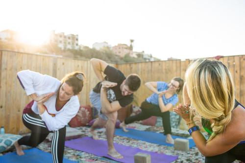 a group of people doing yoga on mats at The Lunar Surf House in Tamraght Ouzdar