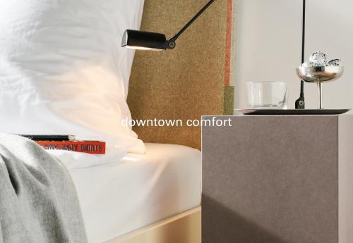 a lamp sitting on a bed with a white pillow at Haus im Tal in Munich
