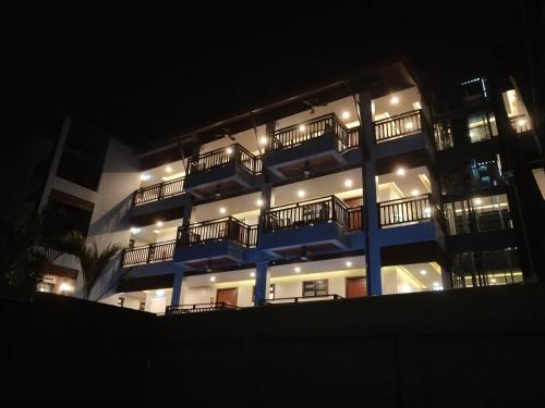 a large building with lights on it at night at Hotel De Sripoom in Chiang Mai