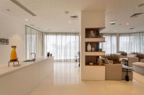 a kitchen and living room with a counter and a couch at Longevity Health & Wellness Hotel - Adults Only in Alvor
