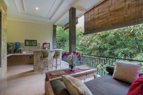 a living room with a couch and a table at Kukuh House Ubud in Ubud