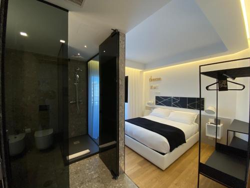 a bedroom with a king sized bed and a shower at MYHOME 75 Premium Luxury B&B in Pescara