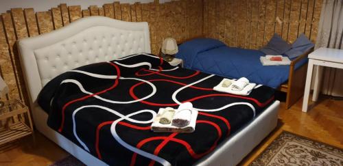 a bedroom with a bed with two pairs of shoes on it at Civico 22 Pisa in Pisa