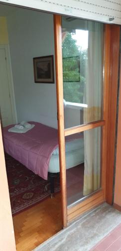 a room with a window with a bed in it at Civico 22 Pisa in Pisa