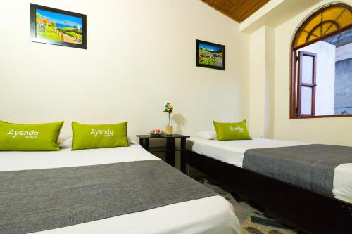 a room with two beds and a window at Ayenda 1411 Caney Sede Ingenio in Cali