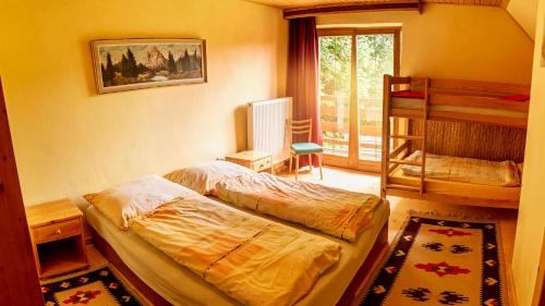 a bedroom with two beds and a bunk bed at U mlynarky in Liptovský Mikuláš