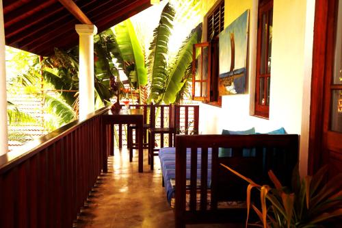 a restaurant with chairs and a bar on a porch at Moonstone Villas in Tangalle