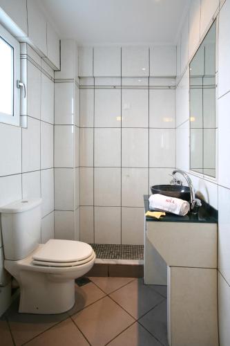 a bathroom with a toilet and a sink at HOTEL HILL in Athens