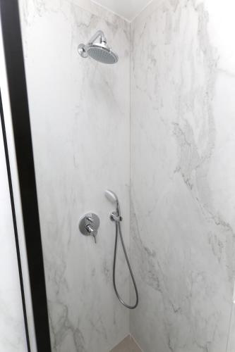 a bathroom with a shower with a stone wall at Magic Stone Apartments in Baška Voda