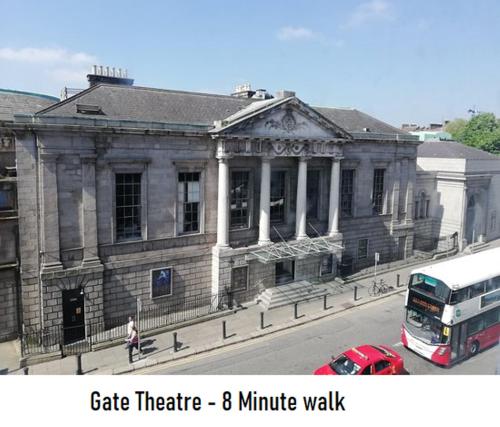 a building with a double decker bus in front of it at Henrietta Suites City Centre in Dublin