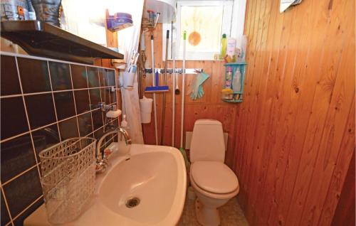 a small bathroom with a toilet and a sink at Beautiful Home In Karrebksminde With 2 Bedrooms And Wifi in Karrebæksminde