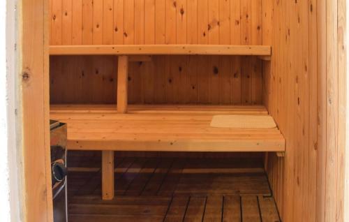 a wooden sauna with a bench inside of it at Holiday Home Ringvejen Rømø Iii in Rømø